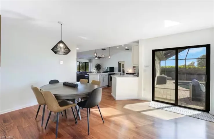 Dining area with light wood-style floors and plenty of natural light