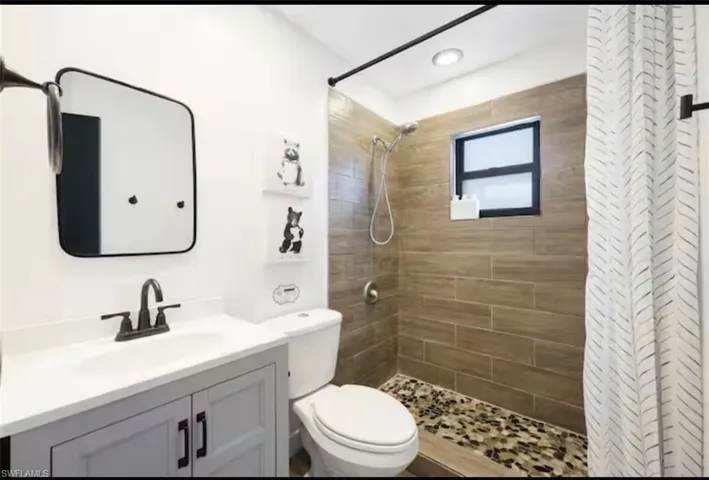 Bathroom with vanity and a stall shower