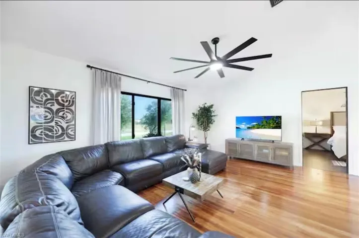 Living area with wood finished floors and ceiling fan