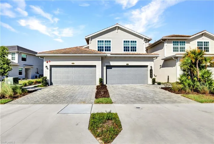 Front of property with central AC and a garage