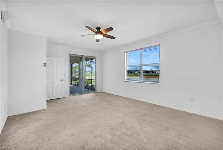 Master bedroom with crown molding, carpet, and ceiling fan