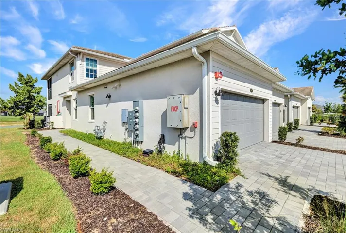 View of property exterior featuring a garage
