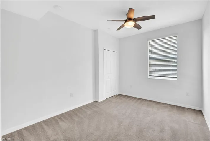 Spare room featuring ceiling fan and carpet flooring