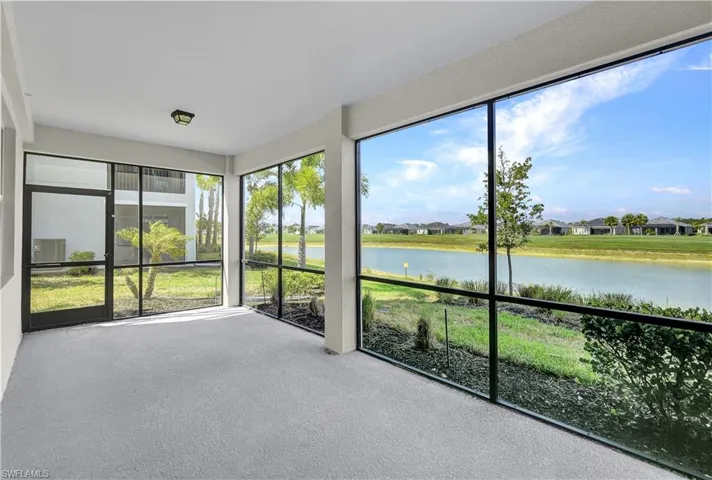 Unfurnished sunroom featuring a water view