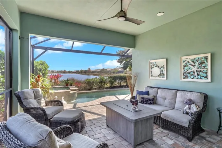 View of patio featuring an outdoor lounge area, glass enclosure, a sunroom, a jacuzzi, and ceiling fan