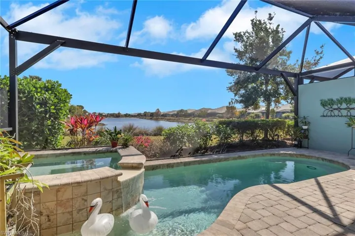 Integrated pool / spa featuring a lanai, a sunroom, a patio area, and a water view