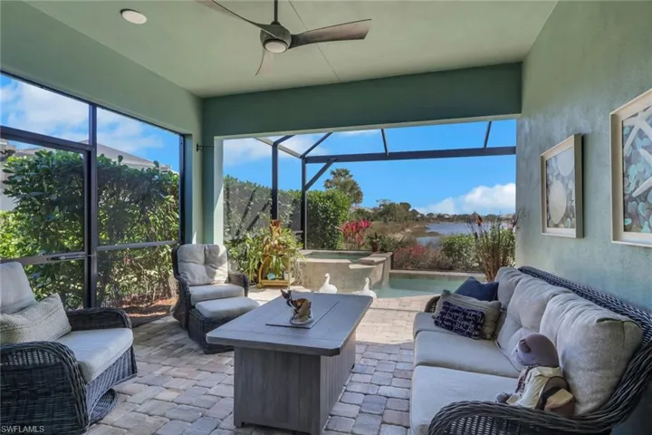 Sunroom with an outdoor hangout area, ceiling fan, a hot tub, and a patio area