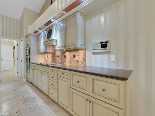 Kitchen w/ Cooktop & Designer Cabinetry