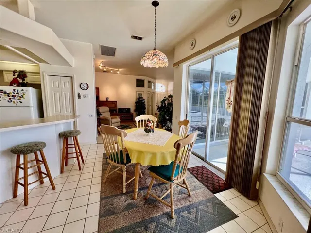 Breakfast nook area featuring a wealth of natural light, visible vents, and light tile patterned floors