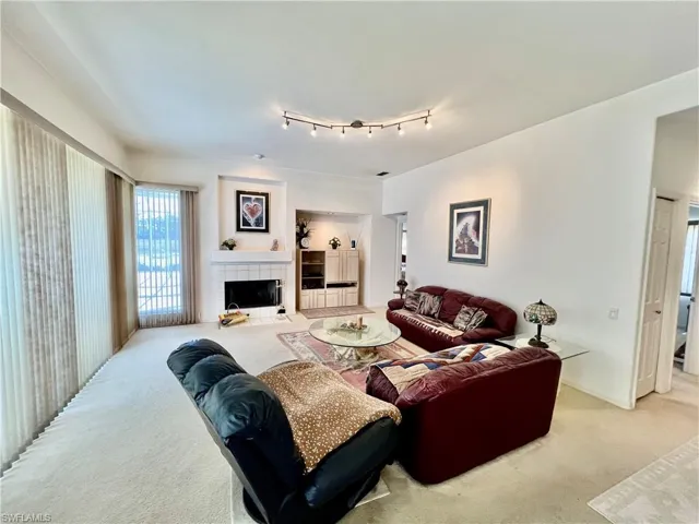 Family room featuring track lighting and a fireplace.
