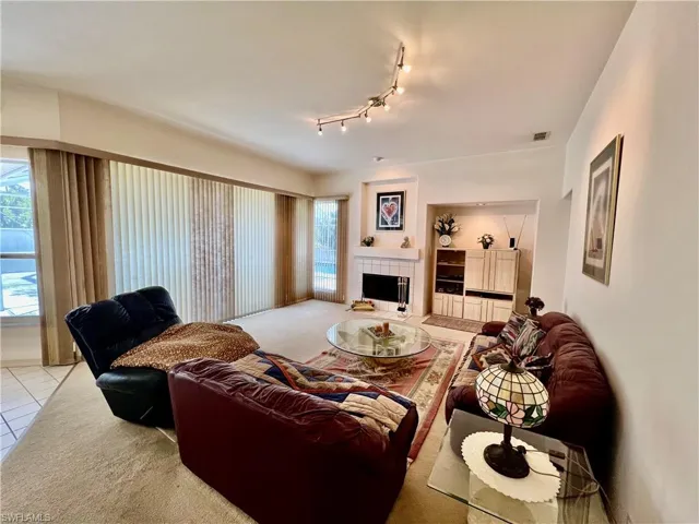 Family room featuring track lighting and a fireplace.