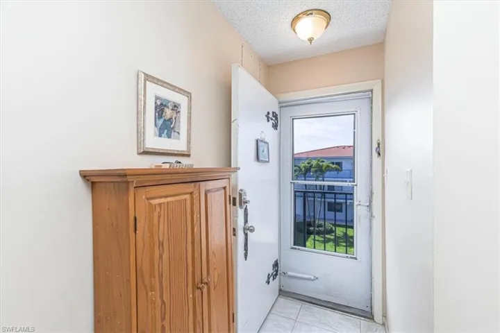 Doorway with a textured ceiling