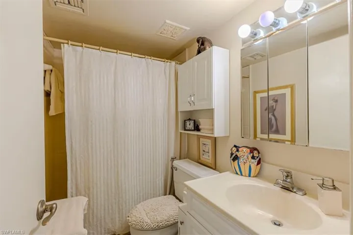 Full bath featuring a shower with shower curtain and vanity