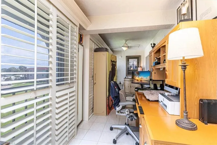Home office with built in desk and a ceiling fan