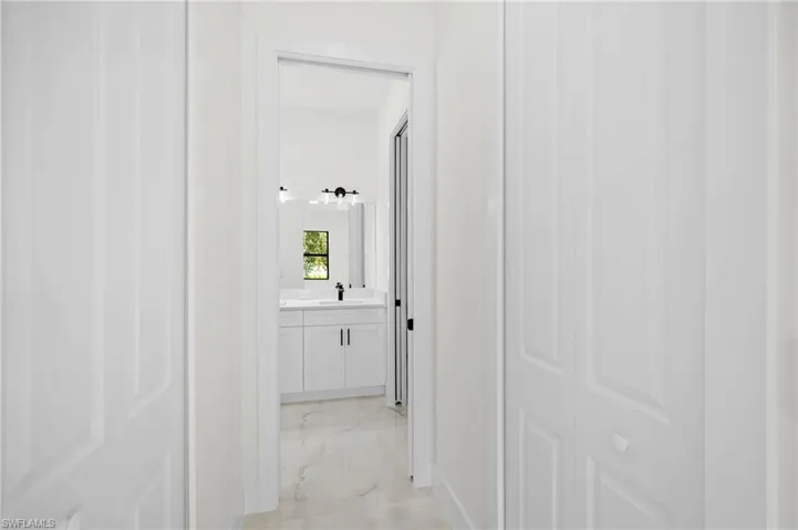Corridor with light marble finish floors