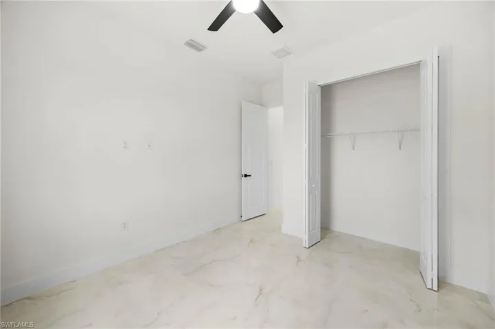 Unfurnished bedroom featuring a closet and ceiling fan