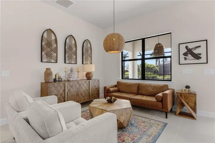 Living area featuring baseboards and tile patterned flooring