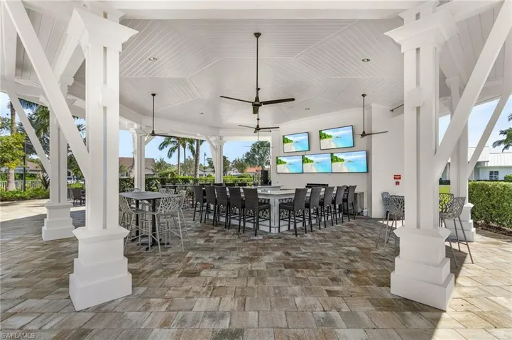 View of patio / terrace featuring an outdoor bar and a ceiling fan