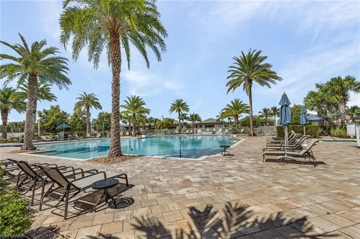 Community pool with a patio