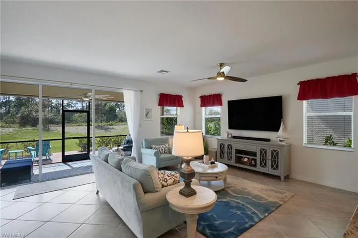 Tiled living area featuring ceiling fan