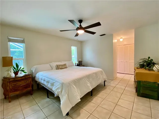 Tiled bedroom featuring a closet and ceiling fan