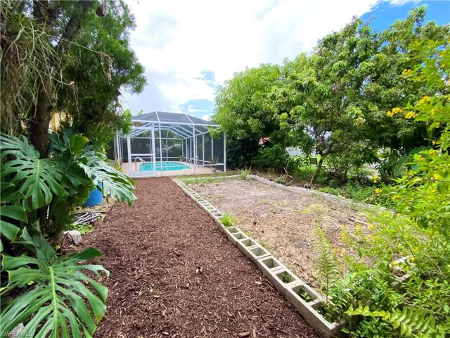 View of yard featuring glass enclosure