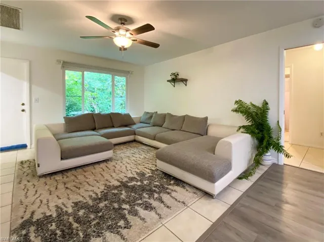 Living room featuring ceiling fan and light hardwood / wood-style flooring