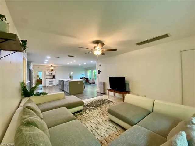 Living room featuring ceiling fan and hardwood / wood-style flooring