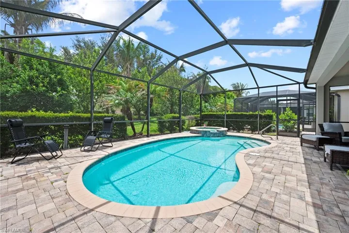 Screened lanai featuring lush perimeter landscaping