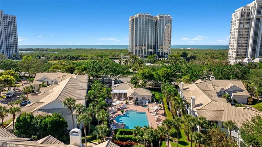 Drone / aerial view of a large body of water and a pool