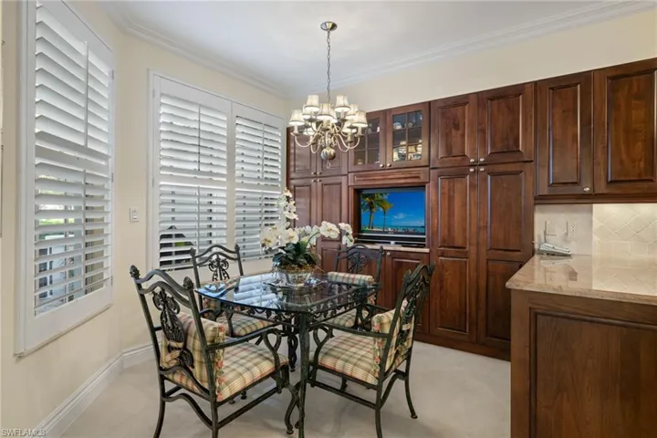 Dining space featuring ornamental molding, a chandelier, and light tile patterned floors