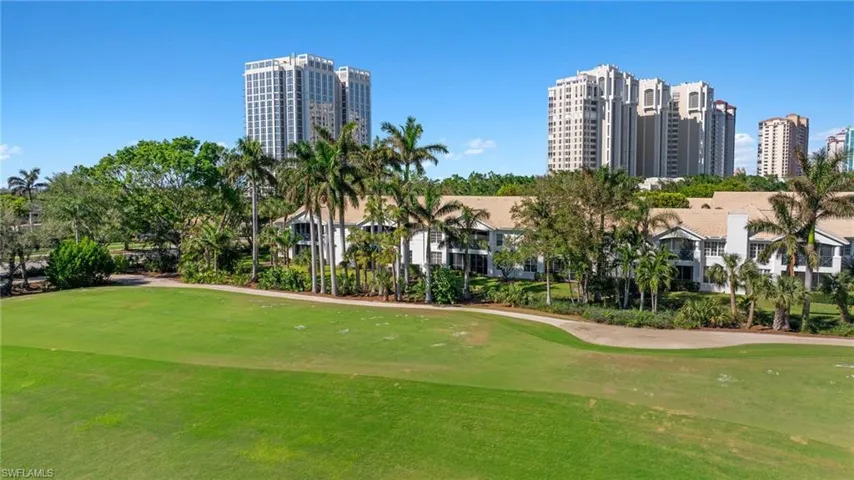 View of property's community with golf course view, a lawn, and a city view