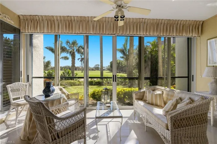 Sunroom featuring golf course view and tile patterned floors