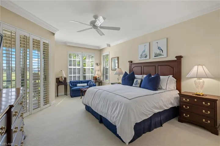 Bedroom featuring crown molding, light carpet, access to exterior, and ceiling fan
