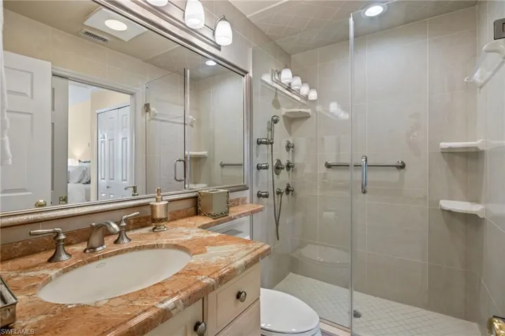 Bathroom with vanity and a stall shower