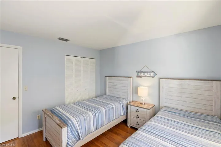 Bedroom featuring dark wood-style floors and a closet
