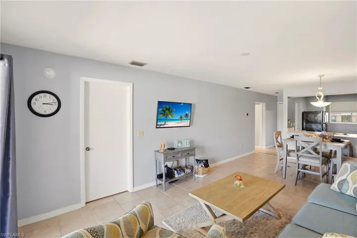 Living room with baseboards and light tile patterned floors