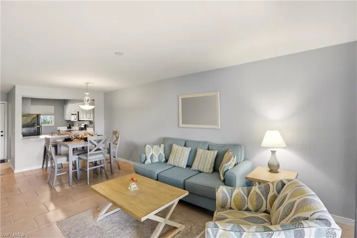 Living room featuring baseboards and light tile patterned floors