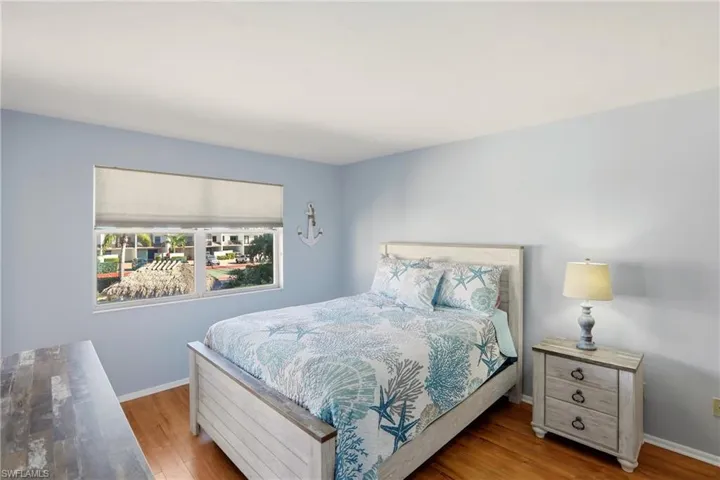 Bedroom with baseboards and wood finished floors