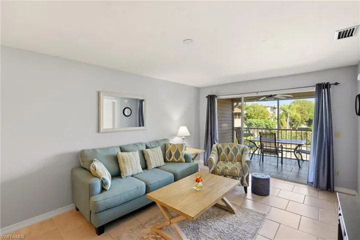 Living room with baseboards and light tile patterned floors