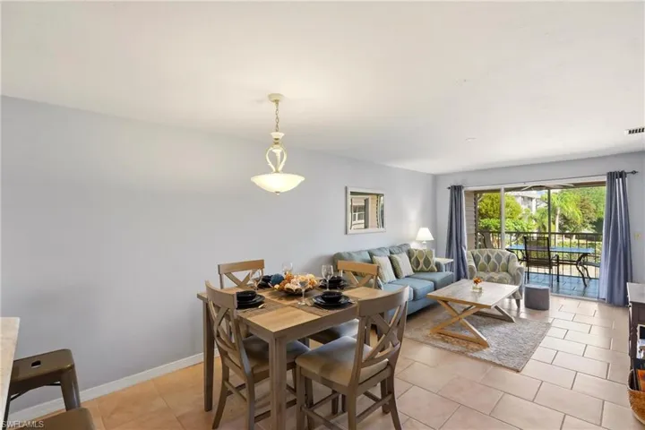 Dining space featuring light tile patterned floors and baseboards