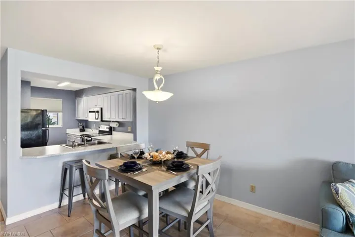 Dining space featuring baseboards and light tile patterned floors