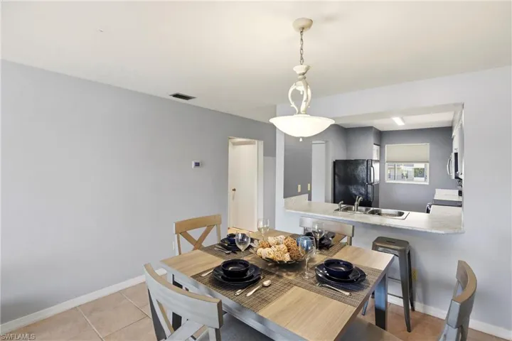 Dining area featuring baseboards and light tile patterned floors