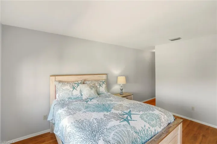 Bedroom featuring baseboards and wood finished floors