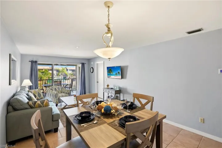 Dining room with baseboards and light tile patterned flooring