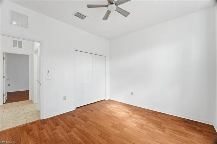 Bedroom 2: Bright & airy room, wood finished floors, large closet, high ceilings and ceiling fan with light