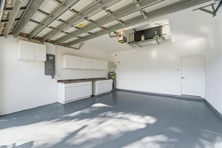 two car garage with cabinet and overhead storage