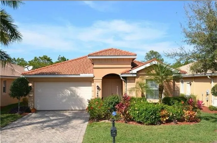 Front of home: Mediterranean / spanish-style house with a tiled roof, driveway, a garage, a front yard, and stucco siding
