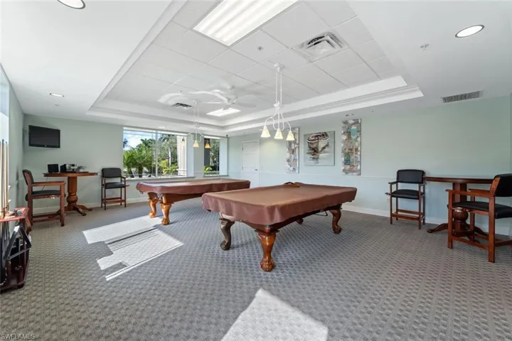 Rec room with a tray ceiling, carpet, baseboards, billiards, and recessed lighting