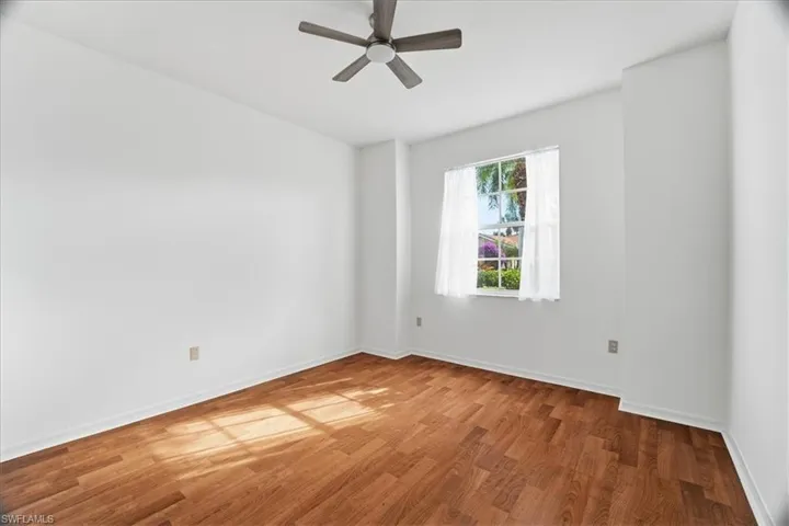 Bedroom 2: Bright and airy room, wood finished floors, large closet, high ceilings and ceiling fan with light